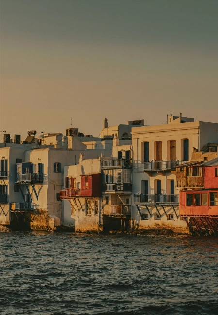 Iconic Little Venice waterfront in Mykonos Town, Greece, featuring traditional Cycladic architecture and scenic harbor views at golden hour.