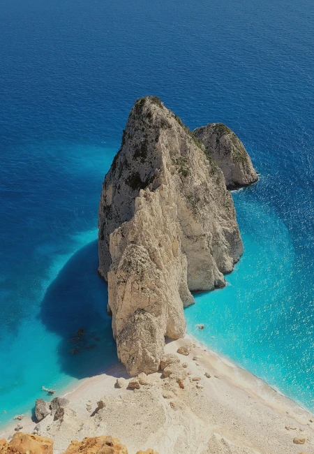 Panoramic view of the Mizithres rocks in Zakynthos, Greece, showing the dramatic white cliffs and bright blue Ionian Sea.
