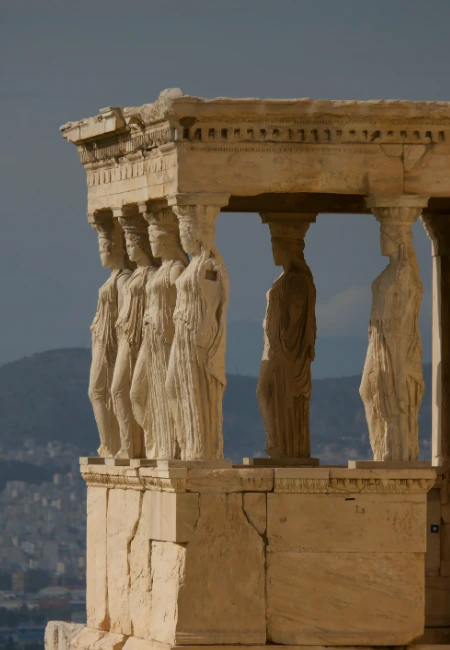 Ancient Greek architecture featuring the Caryatid statues at the Acropolis in Athens, Greece.
